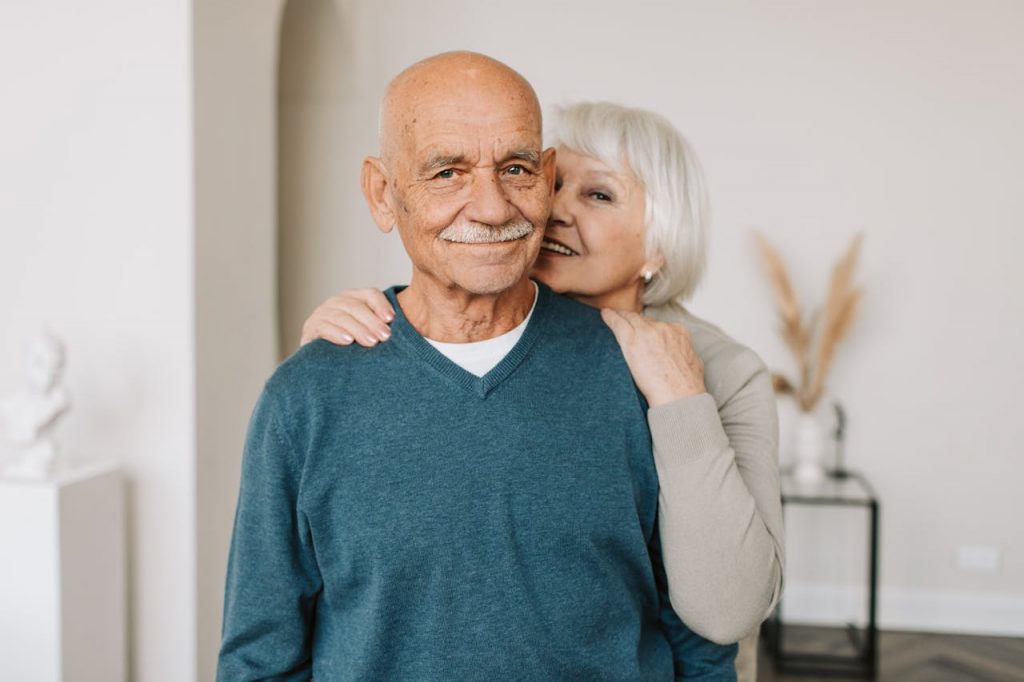 Man in Blue V Neck Sweater and a Woman in Brown Long Sleeve Shirt